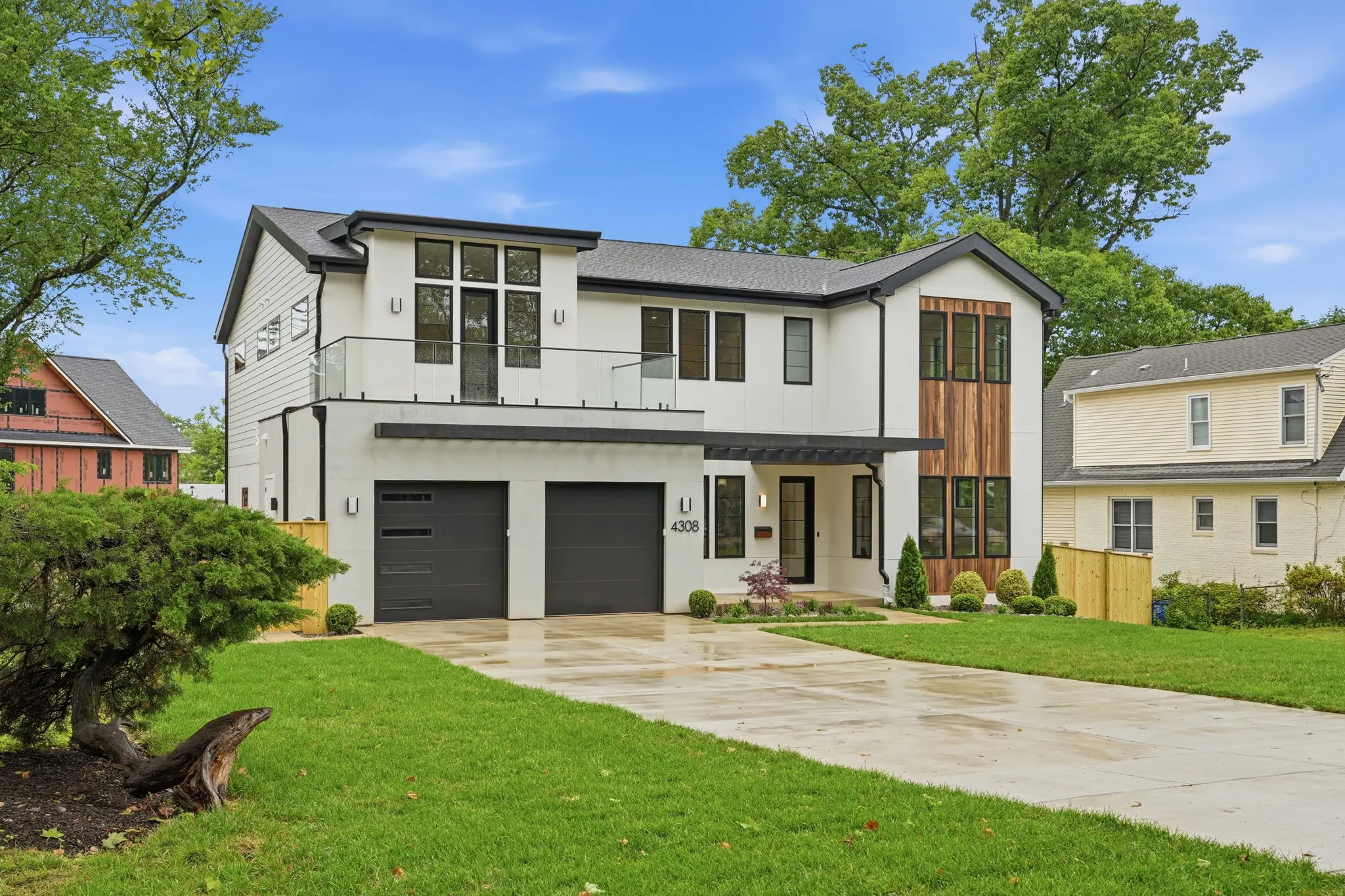 Front elevation of 4308 Dresden St: white modern facade, black window frames, cedar accents