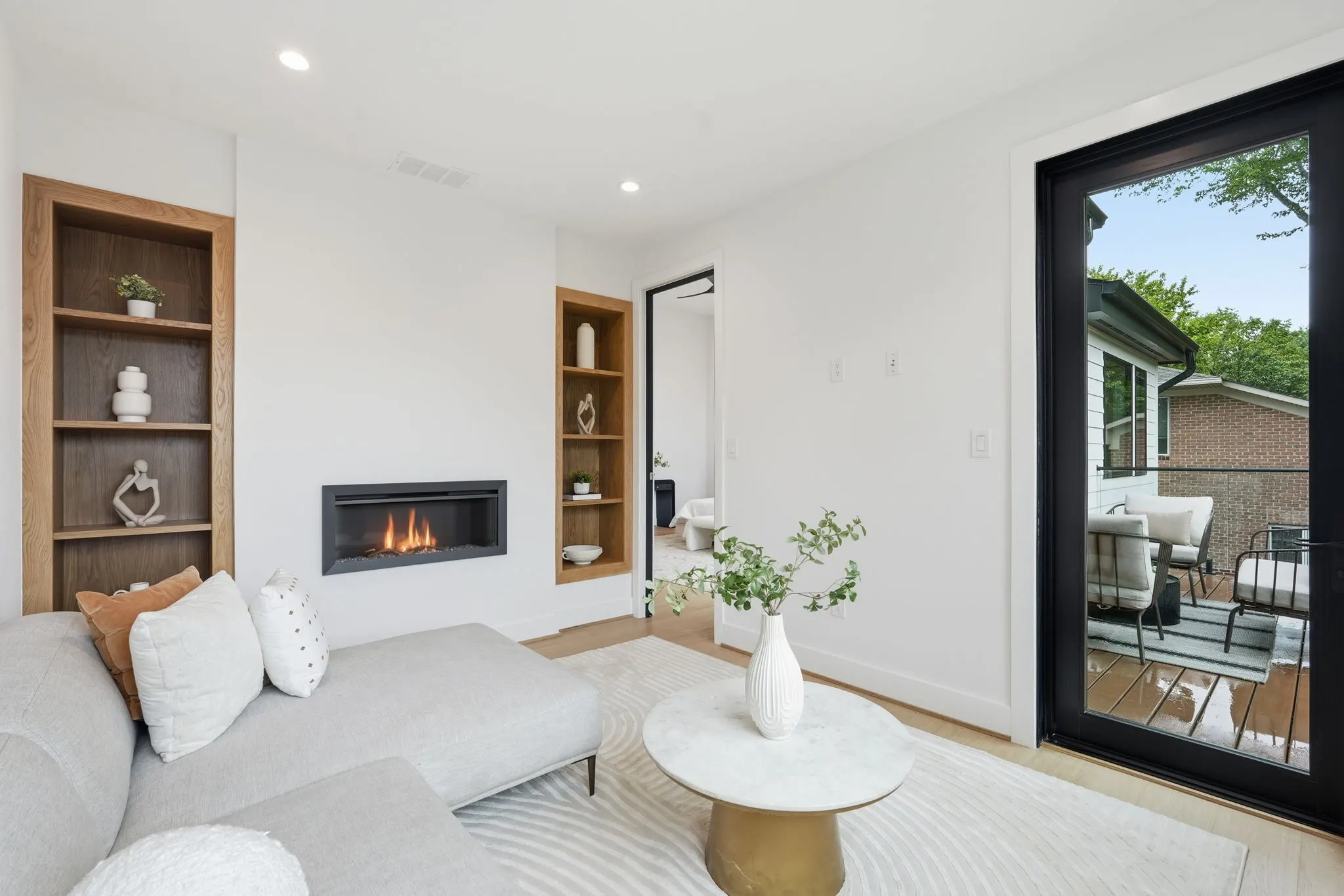 Linear fireplace and built-in wood shelving at 4308 Dresden St, a Colonial custom build